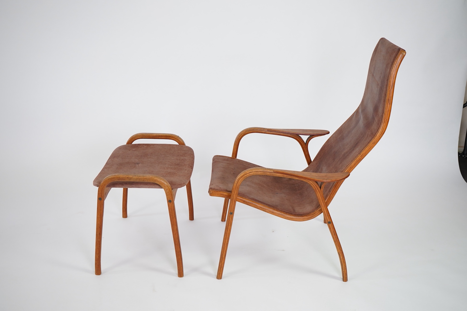 Yngve Ekström (Swedish, 1913-1998) for Swedese Möbler AB: A 'Lamino' oak lounge chair and ottoman